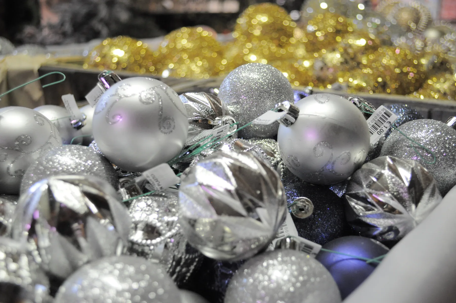 Palline di Natale argentate, lisce e sfaccettate, in una cassetta
